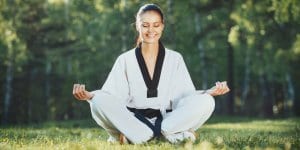 Martial Arts Lessons for Adults in Clinton Township MI - Happy Woman Meditated Sitting Background